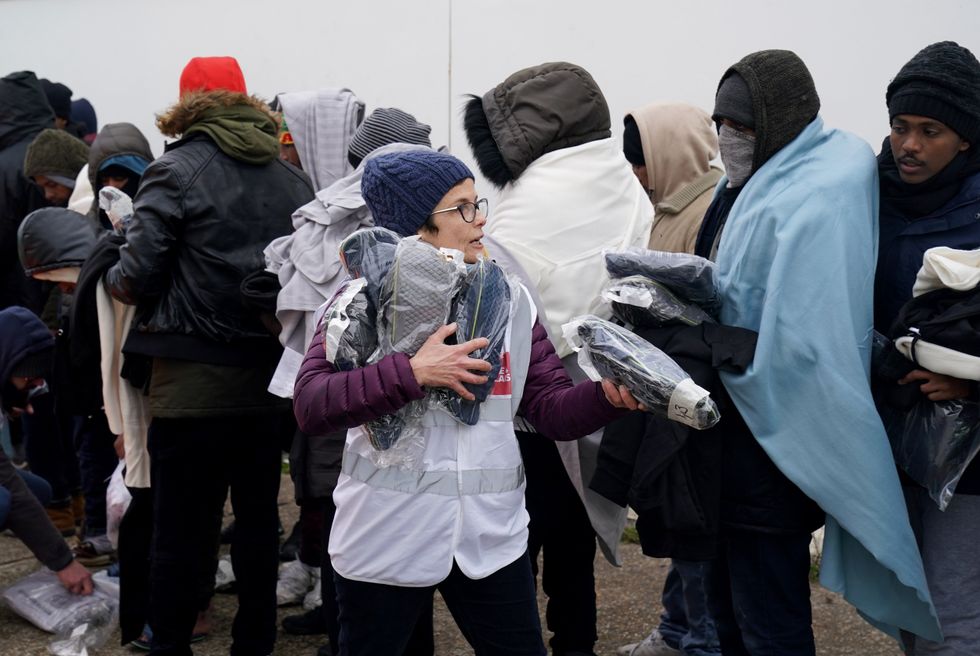 Care4Calais worker hands out freebies to migrants