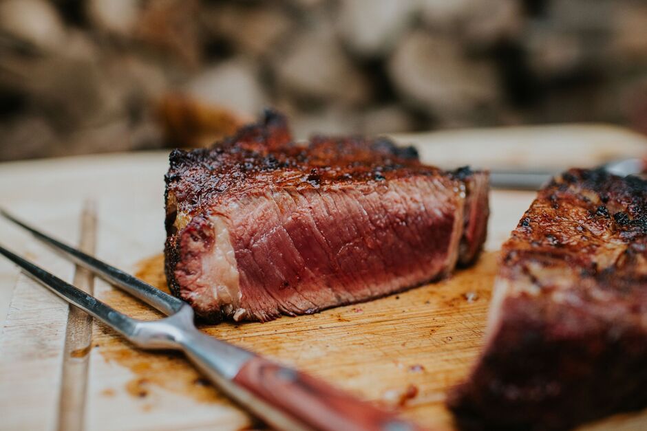 Close-Up of Medium-Rare Steak on wooden board Close-Up of Medium-Rare Steak on wooden board