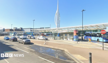 The Spinnaker Tower rises behind the canopy of the bus station in The Hard.