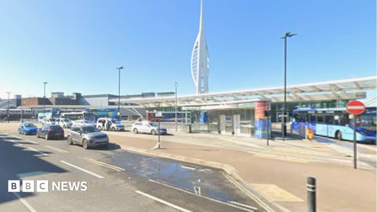 The Spinnaker Tower rises behind the canopy of the bus station in The Hard.