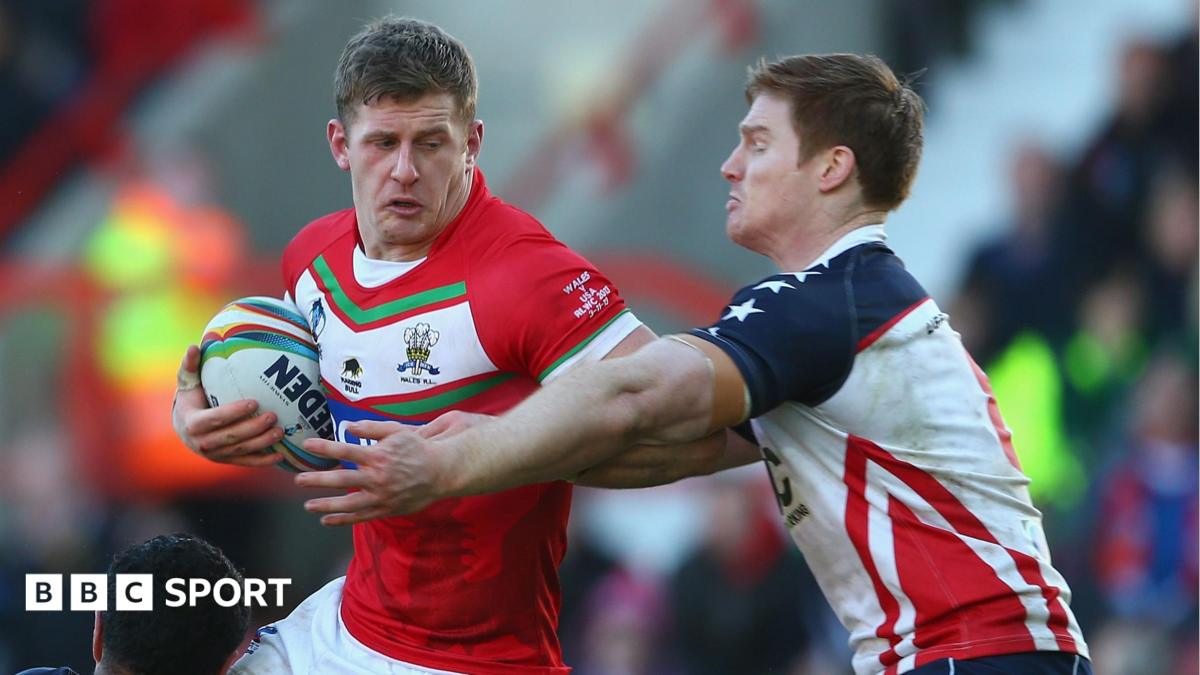 Larne Patrick of Wales is tackled by the USA defence