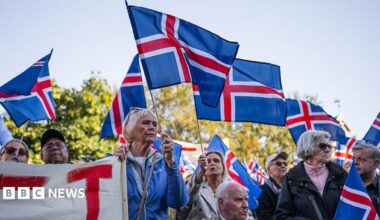 Supporters of the 'No' campaign wave Icelandic flags during a rally against reopening Iceland's European Union accession negotiations in Reykjavik, Iceland, on August 27, 2026