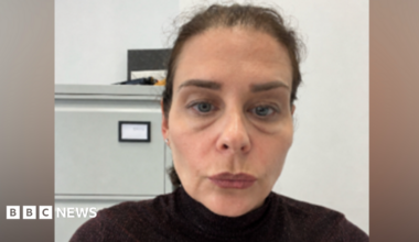 Head and shoulders image of Joanne Bauer in a black polo neck and with large bags under her eyes