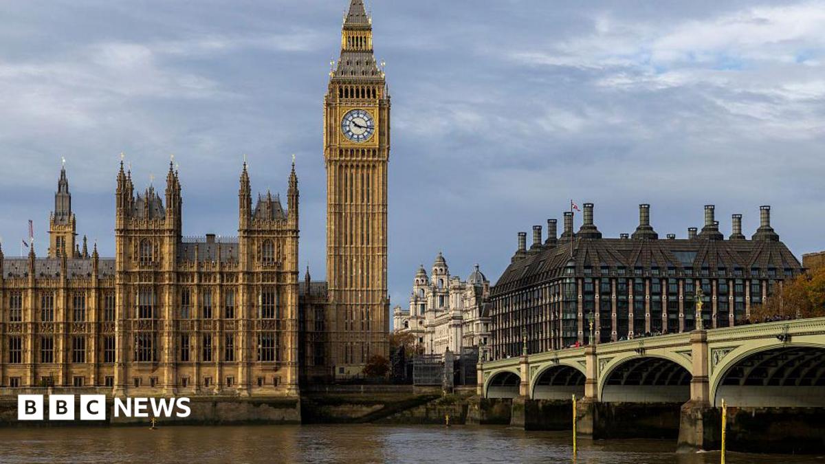 The Elizabeth Tower, known as Big Ben, and the Palace of Westminster beside the River Thames, with Westminster Bridge in the foreground under cloudy skies.