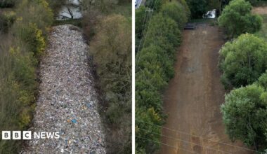 Before-and-after aerial comparison of an illegal waste site in Kidlington. The top image, dated 16 November 2025, shows a long, narrow mound of waste extending through a wooded strip beside a motorway, with text noting the pile was around 6 metres (20 feet) high. The bottom image, dated 21 August 2026, shows the same area after cleanup, with the waste removed and a cleared strip of bare ground visible between trees. Traffic is visible on the motorway in both images.