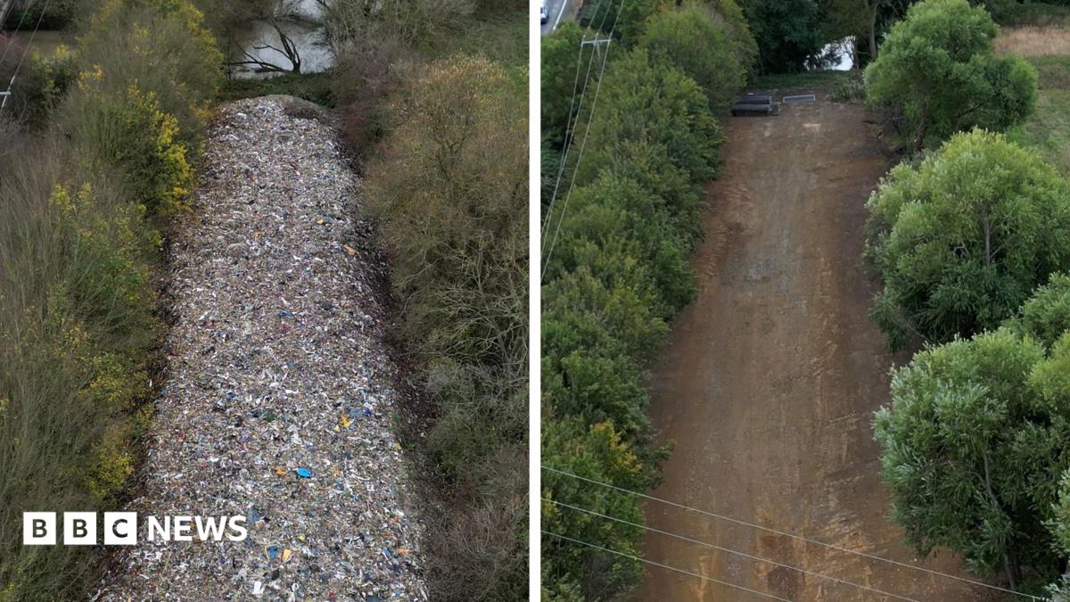Before-and-after aerial comparison of an illegal waste site in Kidlington. The top image, dated 16 November 2025, shows a long, narrow mound of waste extending through a wooded strip beside a motorway, with text noting the pile was around 6 metres (20 feet) high. The bottom image, dated 21 August 2026, shows the same area after cleanup, with the waste removed and a cleared strip of bare ground visible between trees. Traffic is visible on the motorway in both images.