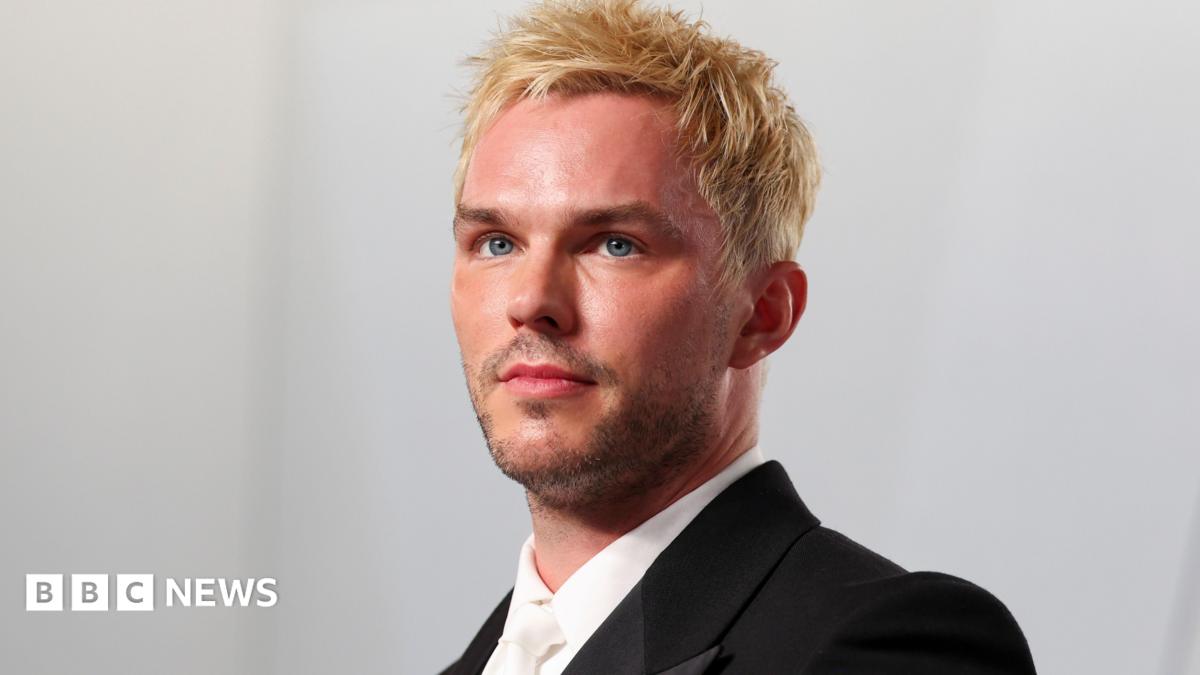 Nicholas Hoult looking slightly off camera with dyed blond hair, white shirt and tie and black dinner jacket at the 2026 Vanity Fair Oscar Party held at the Los Angeles County Museum of Art