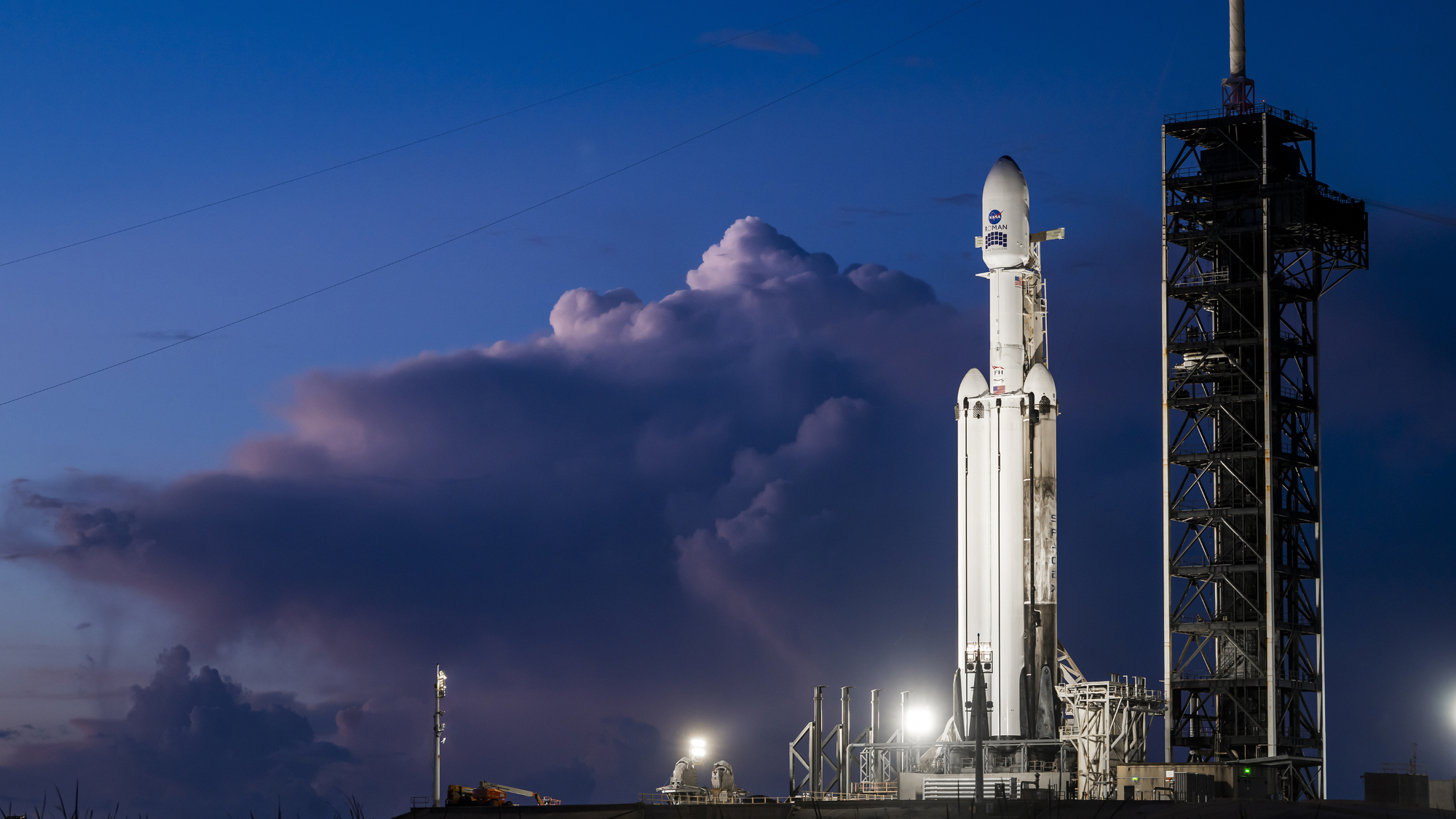A SpaceX Falcon Heavy rocket carrying the Roman Space Telescope on the launch pad in Florida.