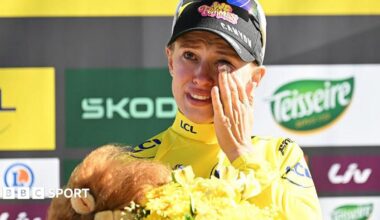 Katarzyna Niewiadoma-Phinney wipes away a tear on the podium after winning stage seven of the 2026 Tour de France Femmes