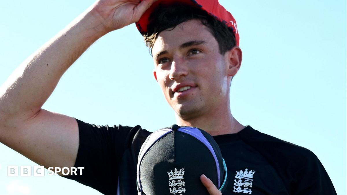 John Turner wearing a blue England top and holding a blue England cap