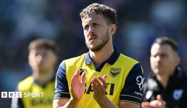 Will Vaulks applauding in an Oxford shirt