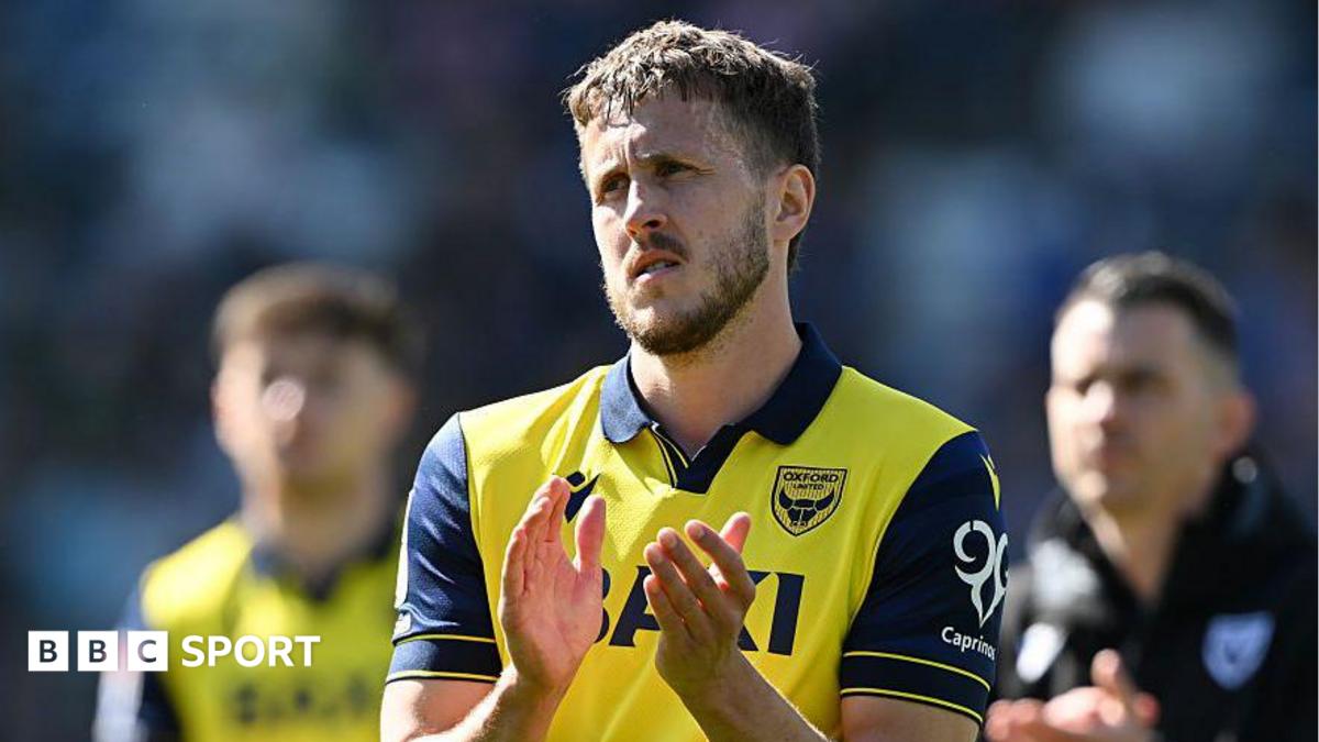 Will Vaulks applauding in an Oxford shirt