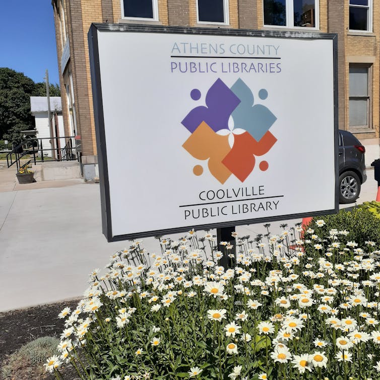 A library sign reading 'Coolville Public Library'
