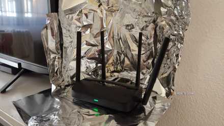 A Wi-Fi 7 router surrounded by aluminum foil.