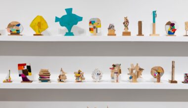 a collection of small abstract wooden sculptures painted in vibrant colors by damien hoar de galvin on white shelves