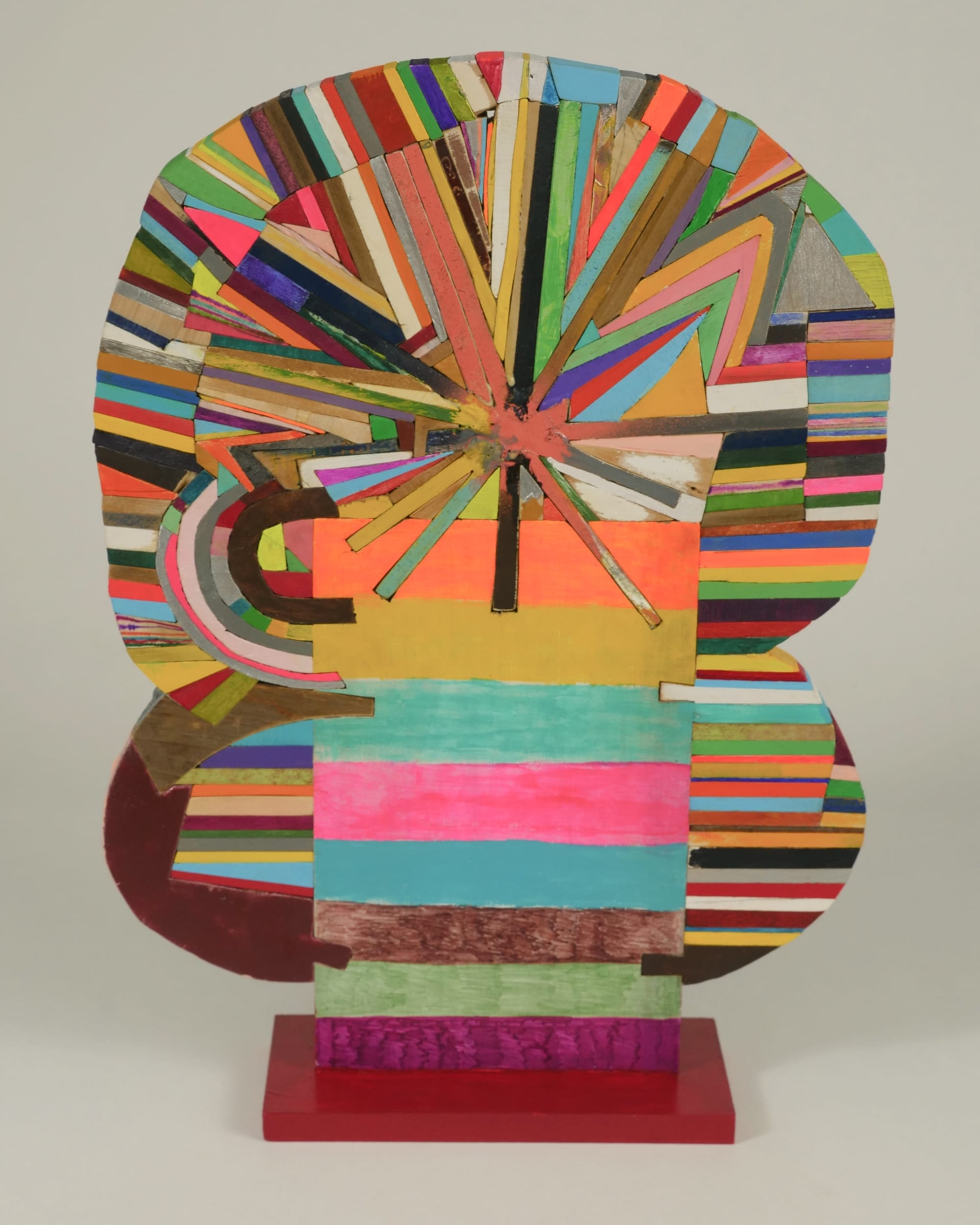 a small abstract wooden sculpture painted in vibrant colors by damien hoar de galvin