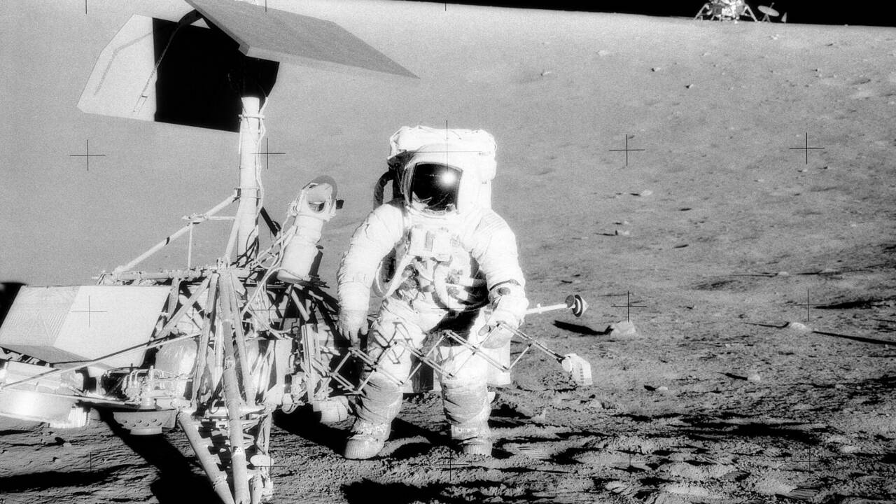 Commander Pete Conrad studies the Surveyor 3 spacecraft, which had landed two years previously, and the Apollo Lunar Module. Credits - Wikipedia Commons image (69)