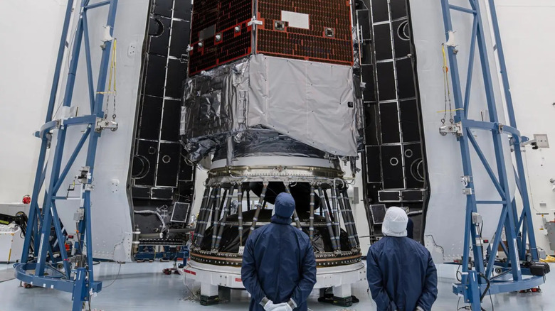 Two people looking up at a spacecraft