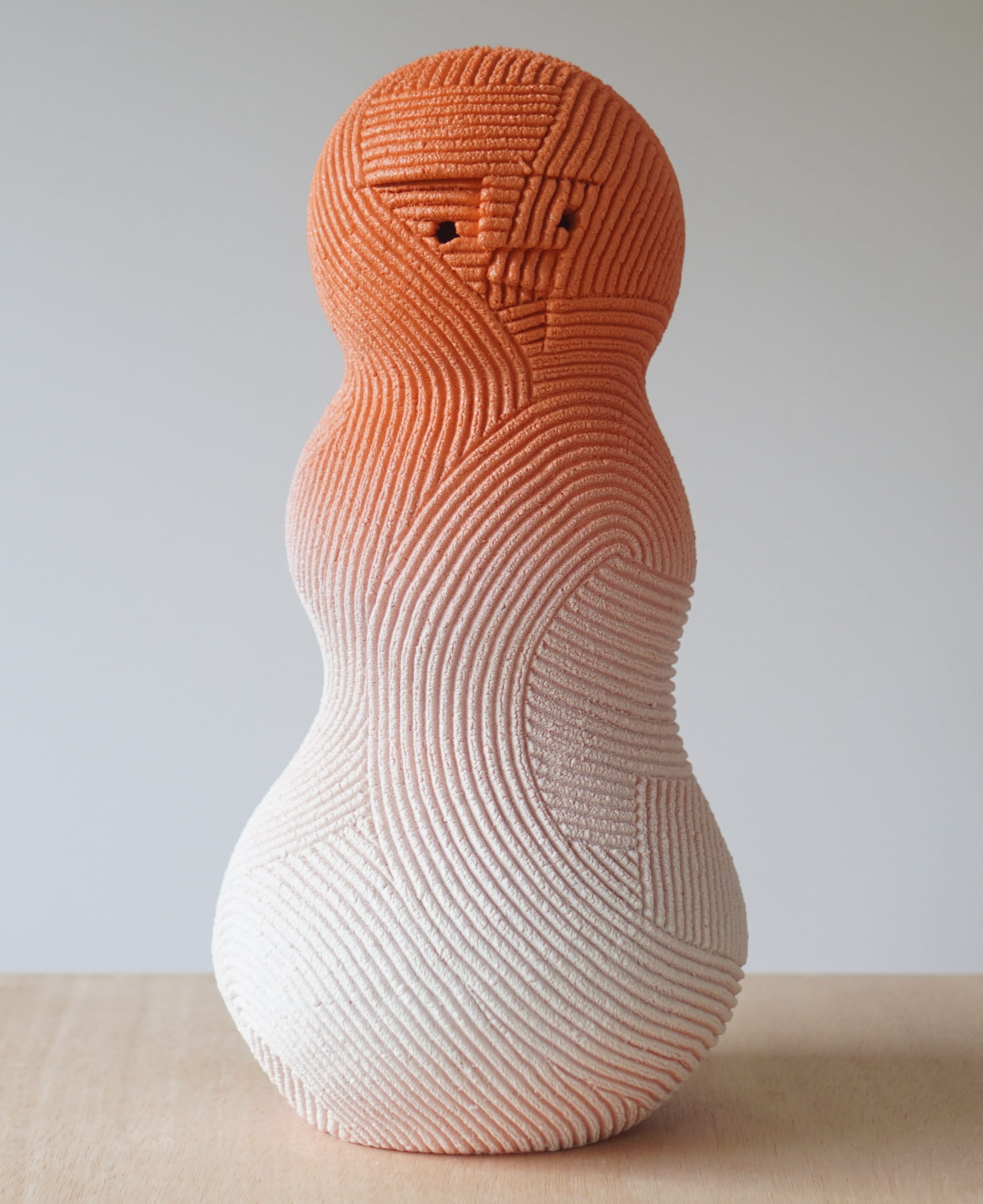 an abstract ceramic sculpture by en iwamura with a tiny face