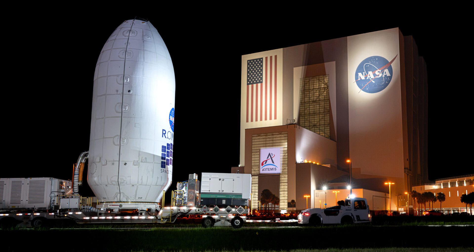 A nighttime shot of the Nancy Grace Roman Space Telescope encapsulated in its payload fairing, traveling to the SpaceX hangar at Launch Complex 39A at NASA’s Kennedy Space Center.
