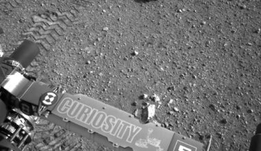Every turn of Curiosity’s six aluminium wheels stamps the letters JPL into Mars in Morse code — a signature hidden in dots and dashes that is not merely decorative, because the rover photographs those tracks to measure how far its wheels slipped on sand and rock