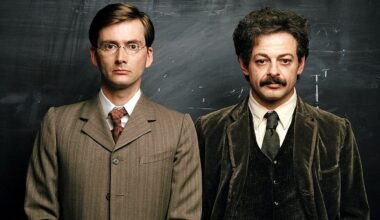 A publicity still from the BBC drama Einstein and Eddington shows David Tennant as Eddington and Andy Serkis as Einstein, standing together in period suits in front of a chalkboard.