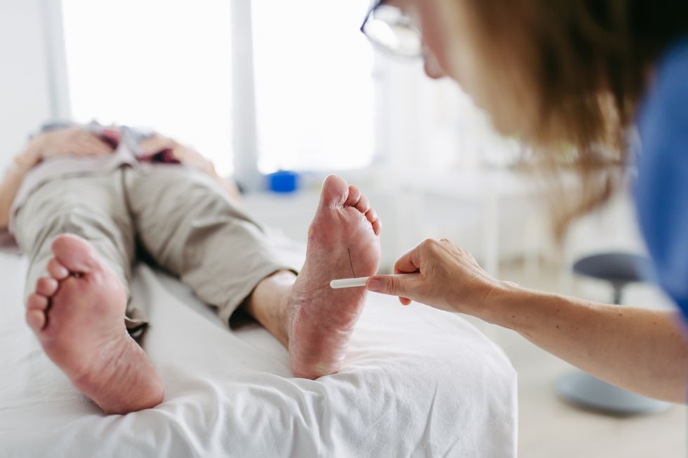 PATIENT HAVING FOOT INSPECTED BY DOCTOR