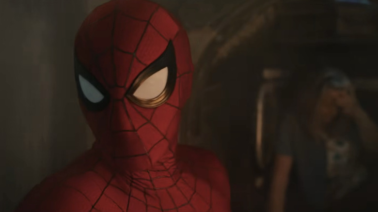 Tom Holland as Spider-Man next to a woman in a crashed tank in Spider-Man: Brand New Day