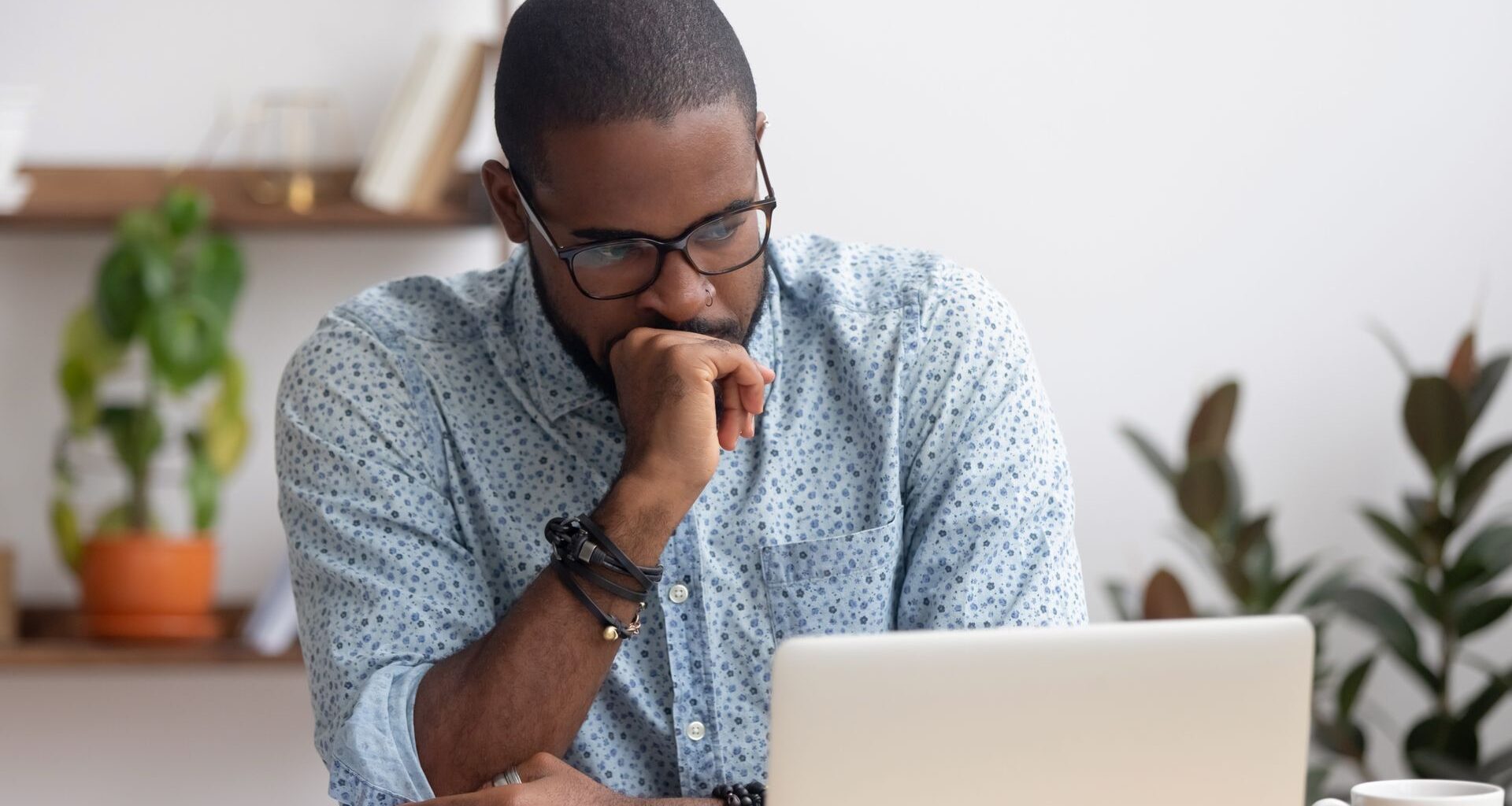 man annoyed at laptop