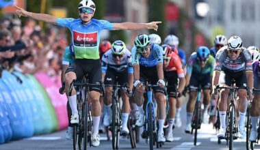 De Lie celebrating in the leader's jersey at the front of a bunch sprint