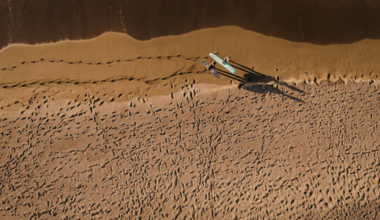 A robotic rover sitting on the surface of Mars photographed real clouds glowing red, green and blue, made of frozen carbon dioxide catching sunlight long after the ground beneath them had gone dark