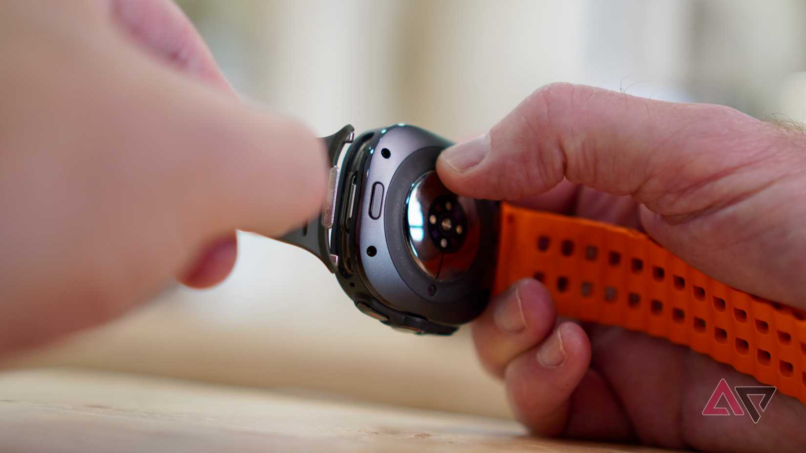 A person putting a Marine Band on the Samsung Galaxy Watch Ultra