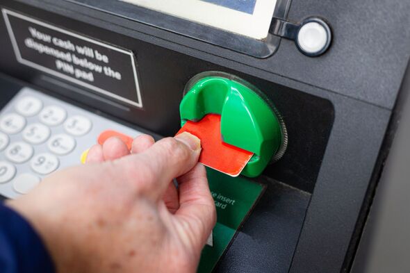 Senior man withdrawing cash from ATM machine