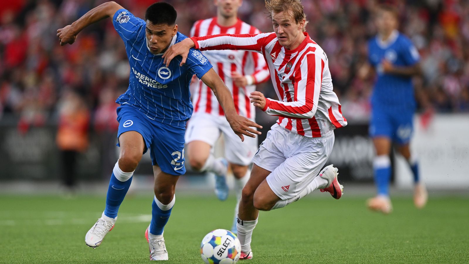 Brighton's Diego Gomez runs with the ball whilst under pressure from Tromso's Mathias Tonnessen