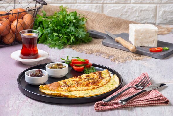 Traditional Turkish Omelet Breakfast Table with Black Tea and Fresh Ingredients Traditional Turkish Omelet Breakfast Table with Black Tea and Fresh Ingredients