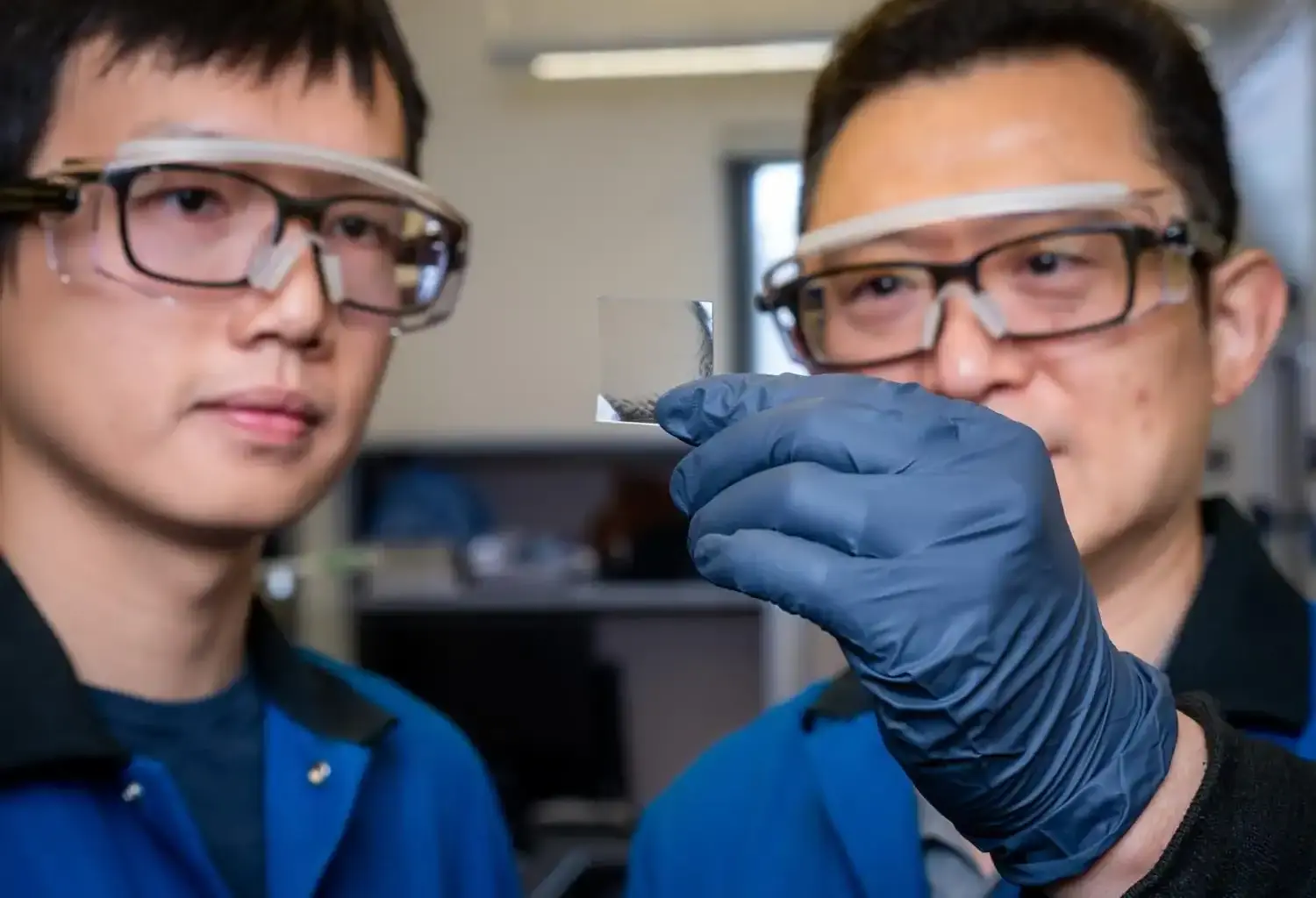 1. Two scientists examining a petri dish in a laboratory setting.