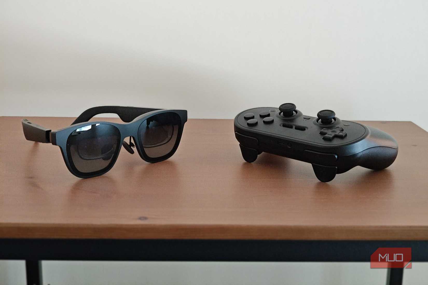 XReal Air 2 Pro glasses next to an 8BitDo Pro 2 controller.
