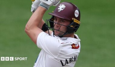 Tom Lammonby wearing a purple Somerset helmet plays a cut shot