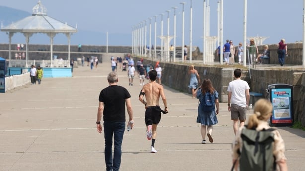 People walk along the pier at Dún Laoghaire