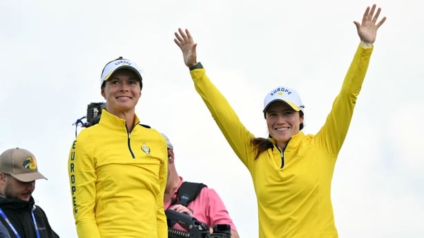 Team Europe's Irish golfer Leona Maguire (R) and Team Europe's German golfer Esther Henseleit (C) react after play in their foursomes match against US players on the second day of the 2026 Solheim Cup biennial team golf competition on The Bernardus Golf Course at Cromvoirt, some 80kms south-east of