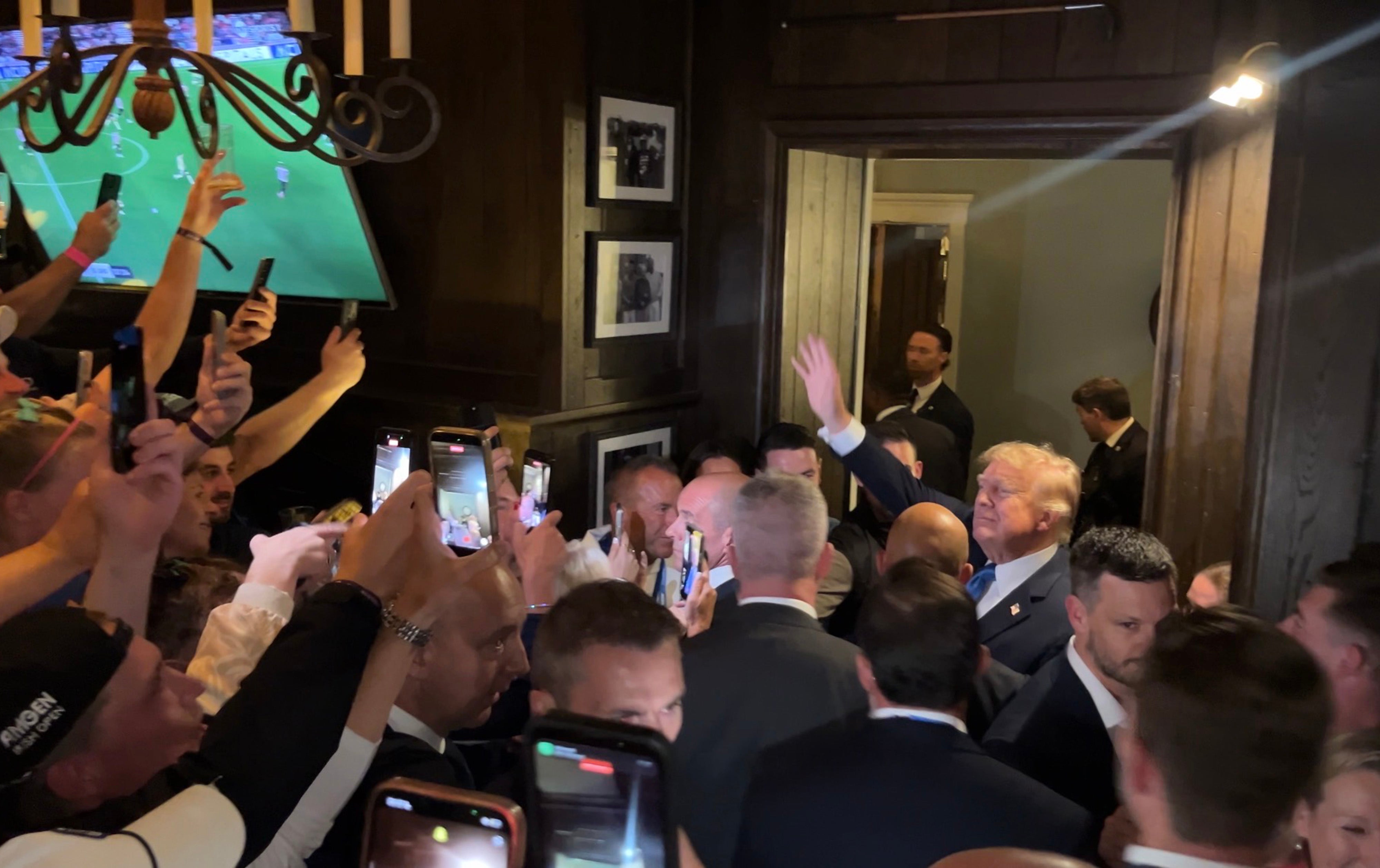US President Donald Trump walks through the members bar of his Doonbeg golf resort as he attends the Irish Open, during his trip to the Republic of Ireland