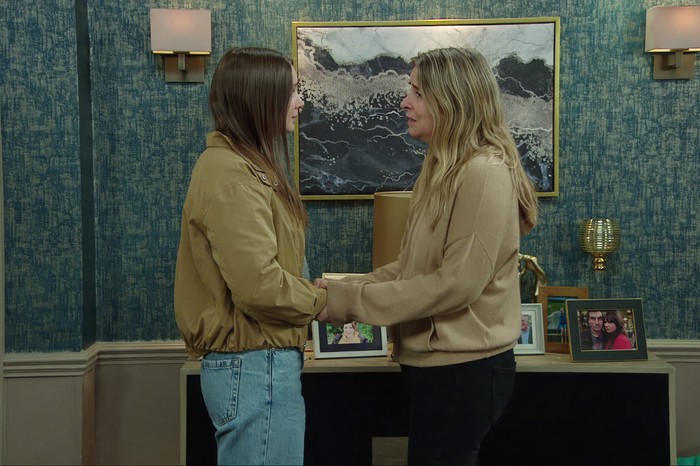07_10_emm_sarah_charity_01 Charity and Sarah hold hands in The Woolpack in a scene from Emmerdale