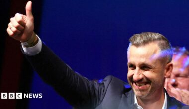 Ulrich Siegmund, leader of the AfD in the state, raises a thumbs up at the election party.