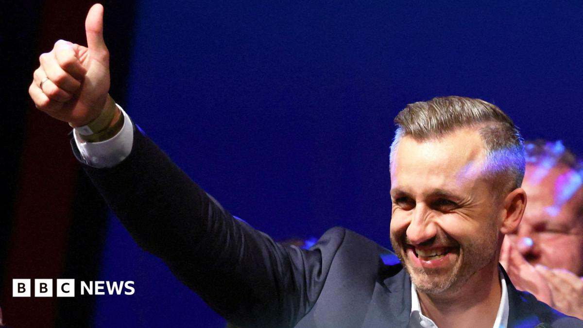 Ulrich Siegmund, leader of the AfD in the state, raises a thumbs up at the election party.