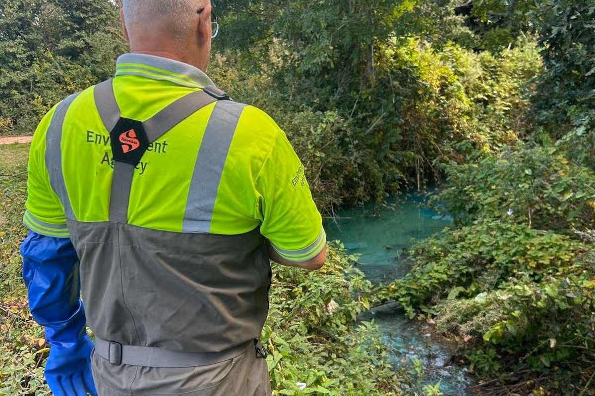 The Environment Agency at Littleham Brook after a pollution incident turned it bright blue.