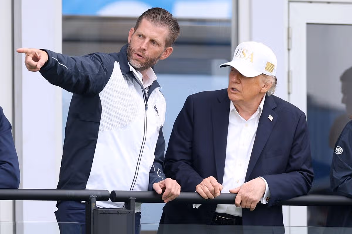 U.S. President Donald Trump speaks with his son Eric Trump on day three of the Amgen Irish Open at Trump International Golf Links in Doonbeg