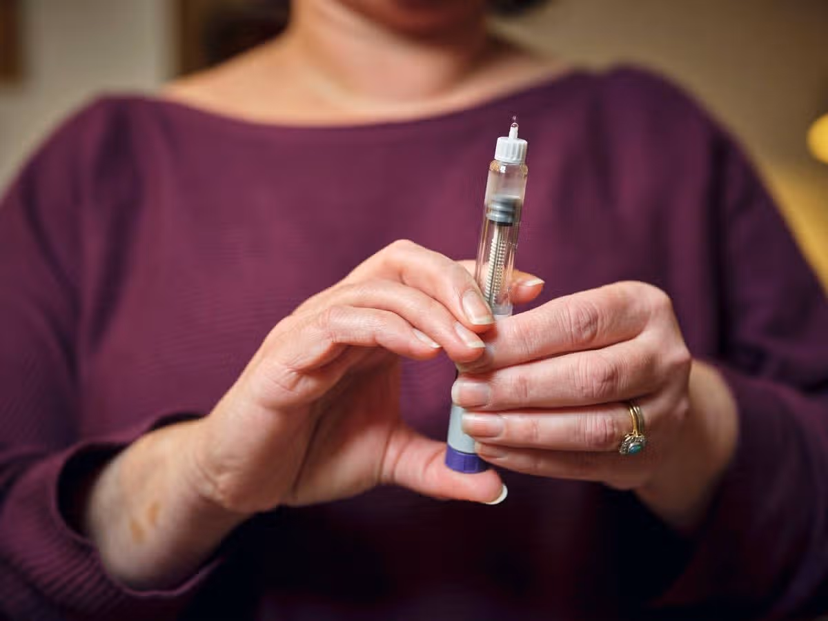 Woman holding weight loss injection