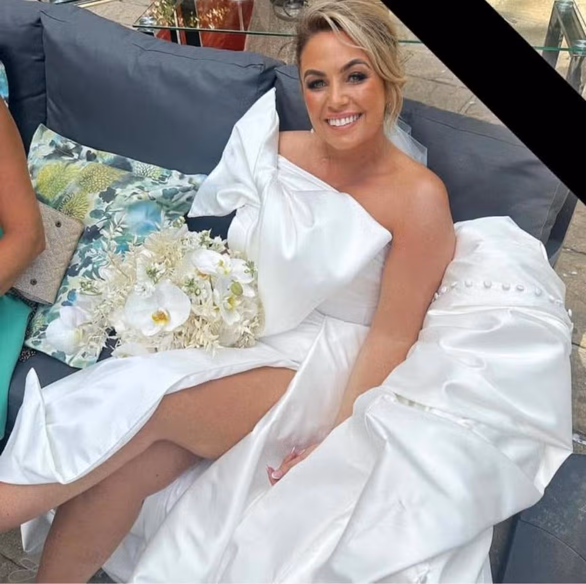 A picture of Sarah in her wedding dress holding her bouquet