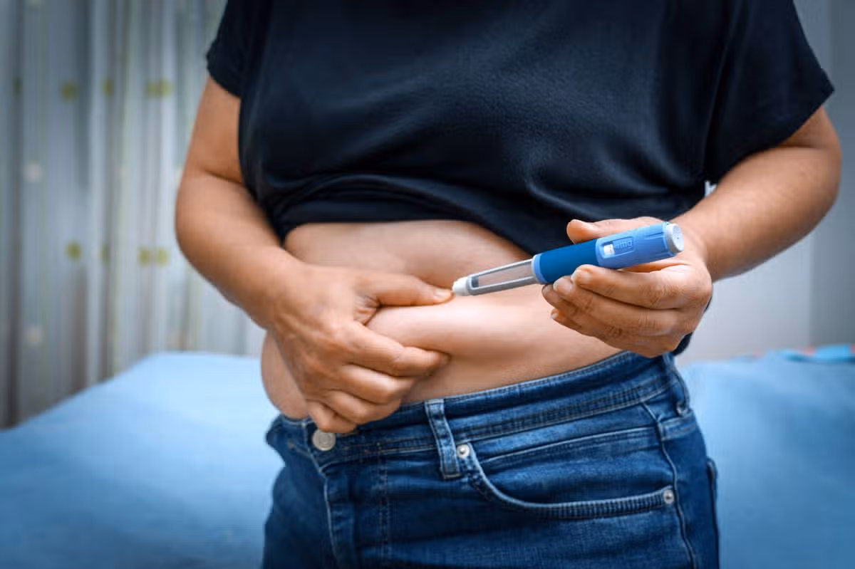 Person injecting insulin into their stomach for diabetes management