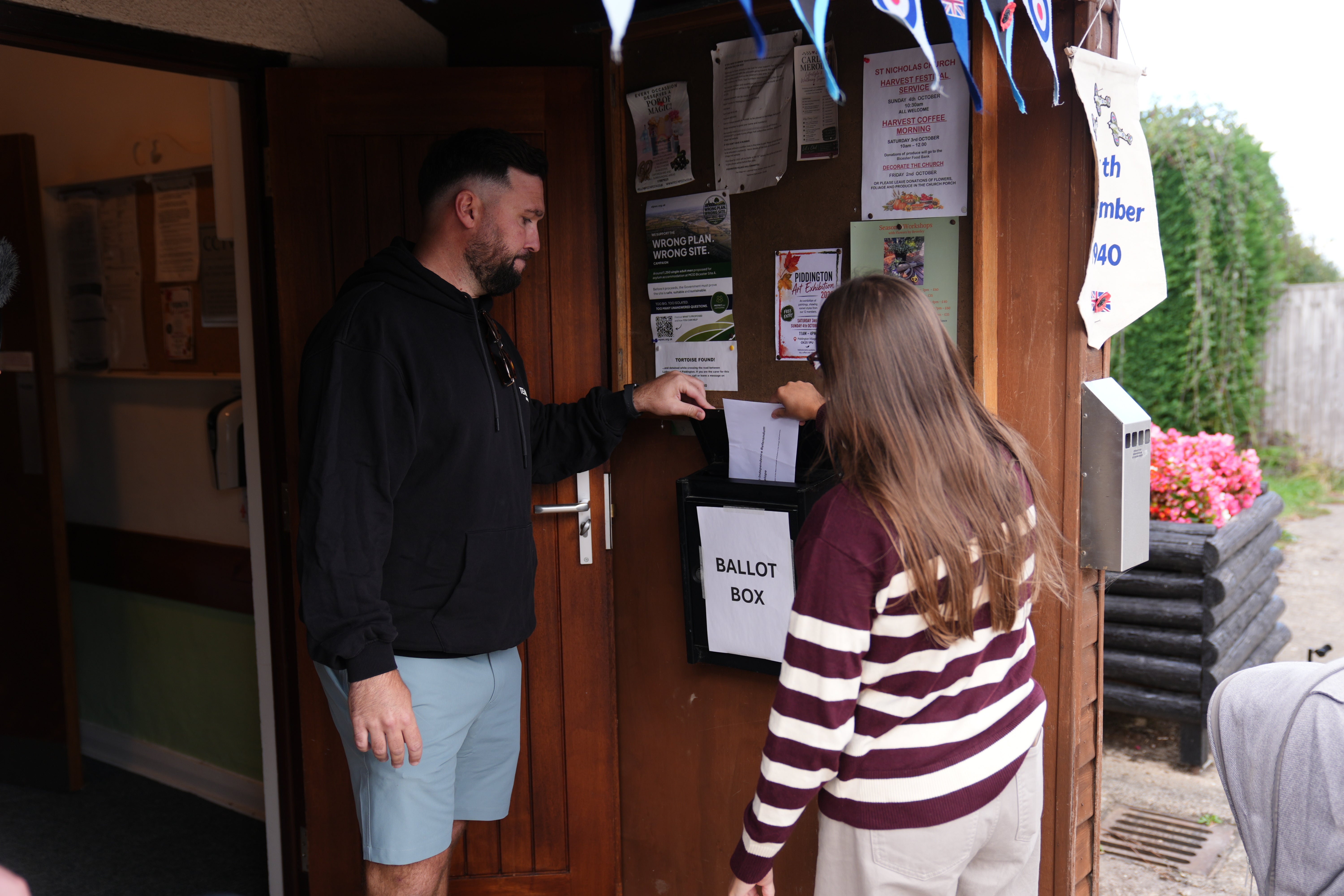 Piddington residents cast their votes at the village hall (Ben Whitley/PA)